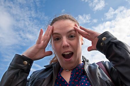 image of a young woman with a surprised expressionの写真素材
