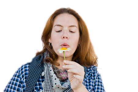 woman detaching petals on a flowerの写真素材