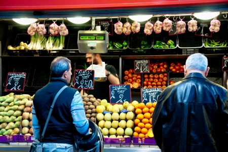 MALAGA, SPAIN - MARCH 31: Unidentified sellers pack fruits at their shop in the popular central market on March 31, 2012 in Malaga, Spain. It was renovated in 2010 and it was reopened on March 2011. のeditorial素材