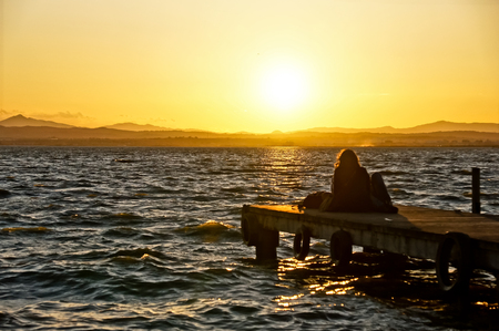 woman looking sundown in Albufera, Valencia, Spain. の写真素材