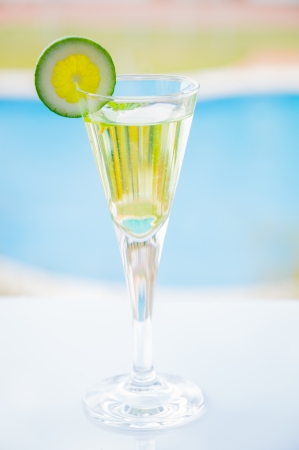 yellow cocktail with a slice of limeの写真素材