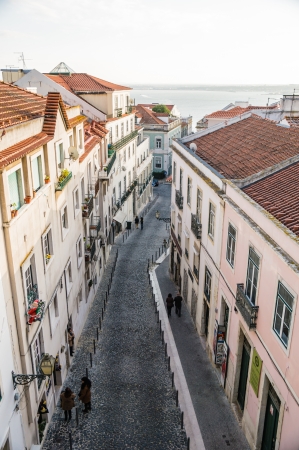LISBOA, PORTUGAL - NOVEMBER 28: Alfama street on November 28, 2013 in Lisbon, Portugal. It is the oldest district of Lisbon, spreading on the slope between the São Jorge Castle and the Tejo river.のeditorial素材