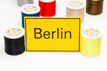 colorful sewing threads with Berlin yellow cardの写真素材