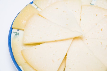plate with slices of spanish manchego cheeseの写真素材
