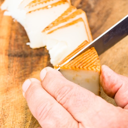 man cutting cheeseの写真素材