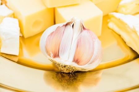Composition with different sorts of cheeses with a garlicの写真素材