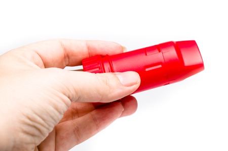 Red Asthma Inhaler in man handの写真素材