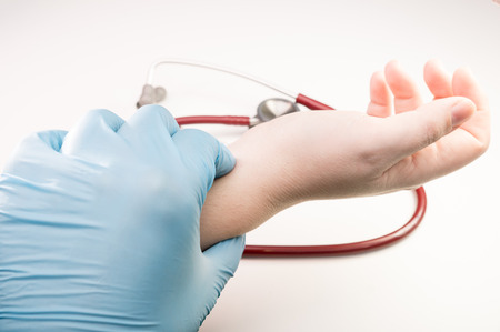 doctor hand taking radial artery pulse