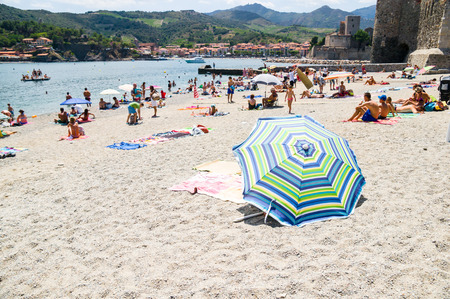 COLLIOURE, FRANCE - JULY  23: Tourists relax in the beach in the small village of Colliure, south France on July 23, 2014 in Collioure, France.のeditorial素材