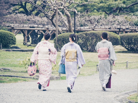 TOKYO, JAPAN - MARCH 20: Unidentified women wearing traditional japanese costumes in Hama Rikyu garden on March 20, 2015 in Tokyo, Japan.のeditorial素材