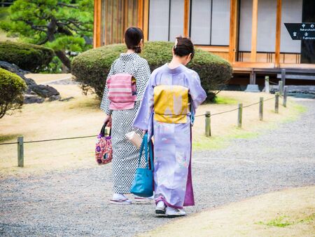 TOKYO, JAPAN - MARCH 20: Unidentified women wearing traditional japanese costumes in Hama Rikyu garden on March 20, 2015 in Tokyo, Japan.のeditorial素材