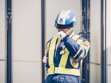 TOKYO, JAPAN - MARCH 20: Unidentified worker in Ginza district on March 20, 2015 in Tokyo, Japan. It is one of the world's best known shopping districts.のeditorial素材