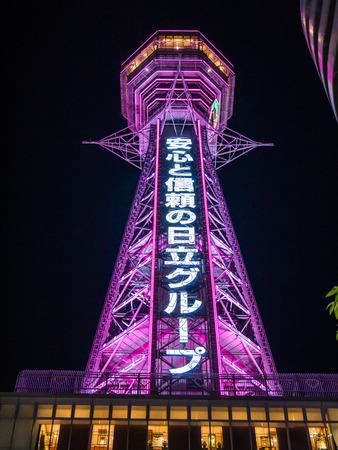 OSAKA, JAPAN - MARCH 25: Tsutenkaku Tower on March 25, 2015 in Osaka, Japan. Tsutenkaku Tower, that advertises Hitachi, is a well-known landmark of Osaka located in the Shinsekai district.のeditorial素材