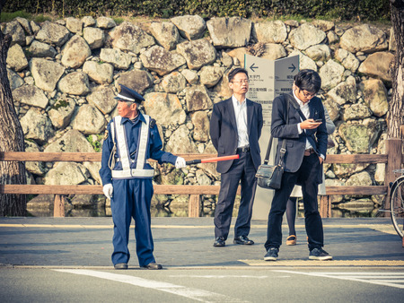 HIMEJI, JAPAN - MARCH 28: police on a zebra crossing on March 28, 2015 in Himeji, Japan. Himeji is a city located in Hyogo Prefecture in the Kansai region of Japan. The city has an estimated population of 535,945.のeditorial素材