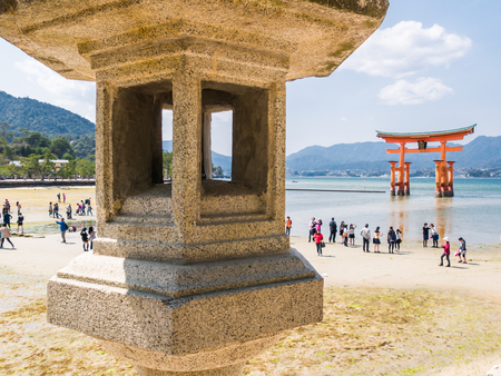 MIYAJIMA, JAPAN - MARCH 28: The famous Floating Torii gate at March 28, 2015 in Miyajima, Japan. Miyajima is a shinto holy site and listed in the World heritage of UNESCO.のeditorial素材