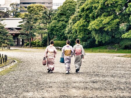 TOKYO, JAPAN - MARCH 20: Unidentified women wearing traditional japanese costumes in Hama Rikyu garden on March 20, 2015 in Tokyo, Japan.のeditorial素材
