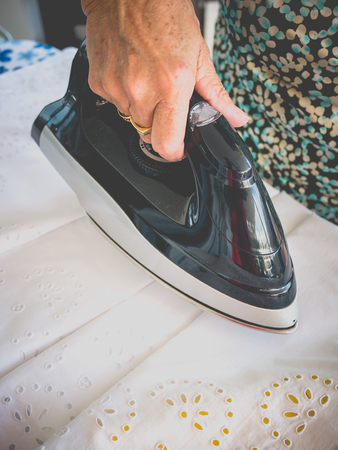 older woman ironingの写真素材
