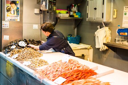MALAGA, SPAIN - JANUARY 16: A man working with fish at central market on January 16 in Malaga,Spain.のeditorial素材