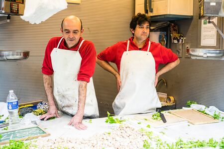 MALAGA, SPAIN - JANUARY 16: A man working with fish at central market on January 16 in Malaga,Spain.のeditorial素材