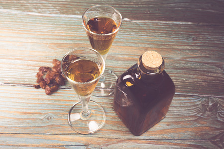 Close-up of glasses of cognac, bottle and raisinの写真素材