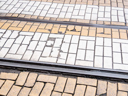 Empty rails on brick pavement.の写真素材