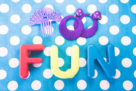 Fun made of plastic letters, blue dotted backgroundの写真素材