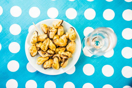 Close-up of green olives, mussels and costume jewelryの写真素材