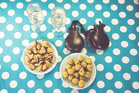 Close-up of green olives, mussels and costume jewelryの写真素材