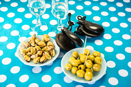 Close-up of green olives, mussels and costume jewelryの写真素材