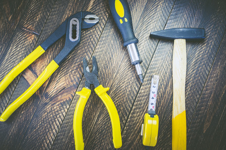 Close-up of different working tools on wooden table