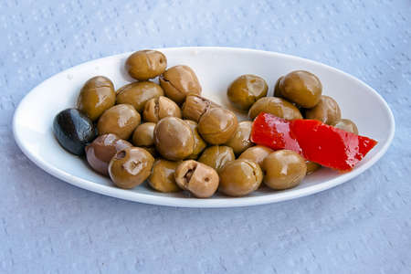 olives in a white plateの写真素材