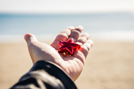 Hand holding Christmas tree decorationの写真素材