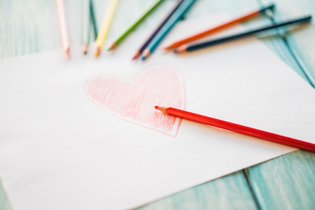 Close-up of red painted heart on paperの写真素材