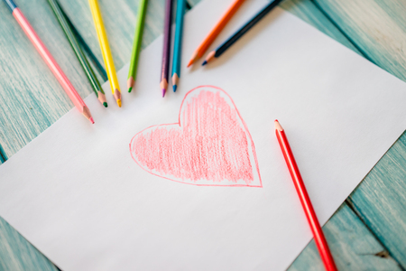 Close-up of red painted heart on paperの写真素材