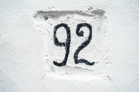House number on white painted wall