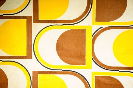 Yellow and brown patterned fabric with designの写真素材