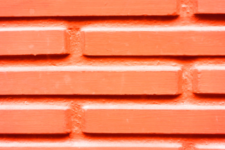 Close-up of red painted wall with wooden planks
