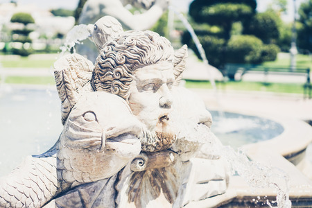 Close-up of Bateria park fountain detail with male head and fish blowing water from mouthの写真素材