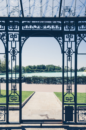 View of turquois pool in sunlight through the metal gates of Bateria park, Torremolinos,Spain.の写真素材