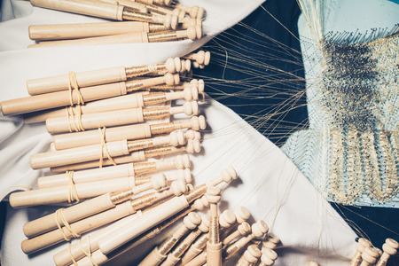 Weaving bobbins with threads in close-upの写真素材