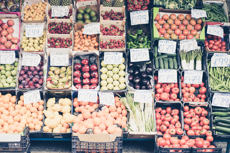 Fresh vegetables and fruit at outdoor marketの写真素材