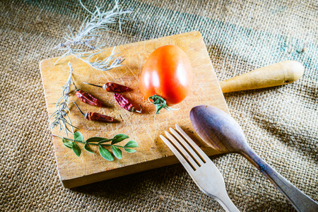 Close-up of dried ingredients on wooden board over textile backgroundの写真素材