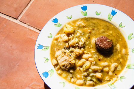 closeup of white plate with fabada asturiana, a typical spanish bean stewの写真素材