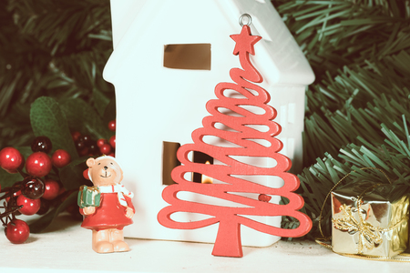 Close up of Christmas decorations and figurine of Santa Claus with bells standing on wooden surface. の写真素材