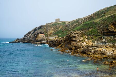 SANTA JUSTA BEACH,CANTABRIA,SPAIN - 31 AUGUST,2016: View of idyllic bay at rocky land with tourists swimming in waterのeditorial素材