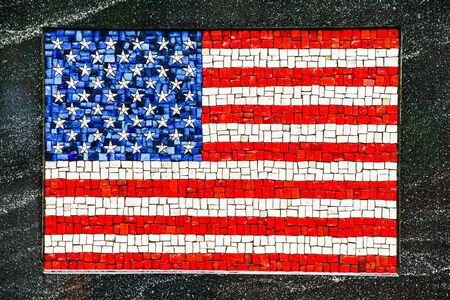 Picture of American flag made of little mosaic tiles on grey textured background.の写真素材
