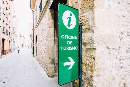 Santo Domingo de la Calzada, la Rioja, Spain - 09.12.2016: Green sign showing direction to tourist office.のeditorial素材