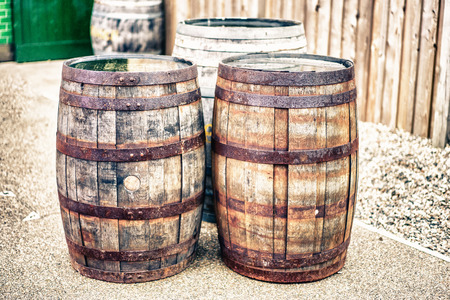 The old rough wooden barrels placed on the ground.