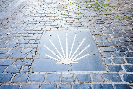 Way of St. James  - 11.09.2016 From above shot of yellow scallop shell symbol on concrete.のeditorial素材
