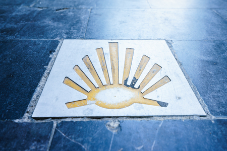 Way of St. James  - 11.09.2016 From above shot of yellow scallop shell symbol on concrete.のeditorial素材